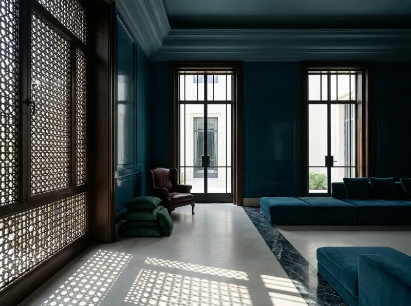 Luxury interior design Dubai — a Gulf villa majlis reception in petrol blue plaster with mashrabiya screen shadow across honed limestone, by Beverly Hills Luxury Interiors