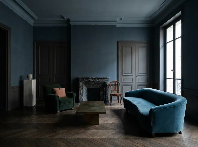 Quiet luxury interior design salon in slate blue lime plaster with deep cornice, dark oak herringbone parquet and mixed-provenance seating — Beverly Hills Luxury Interiors