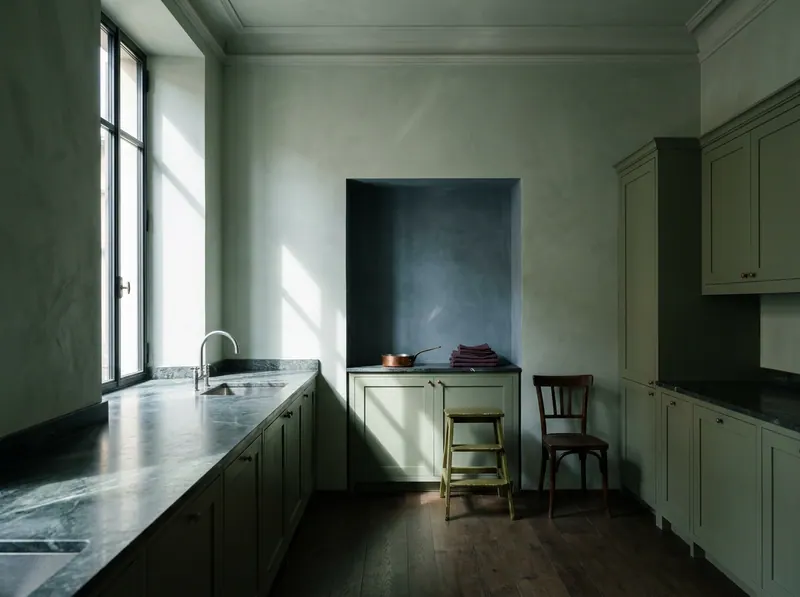 Non toxic home kitchen in celadon lime plaster, sage solid timber joinery with natural oil finish and honed veined stone worktop — Beverly Hills Luxury Interiors material purity specification