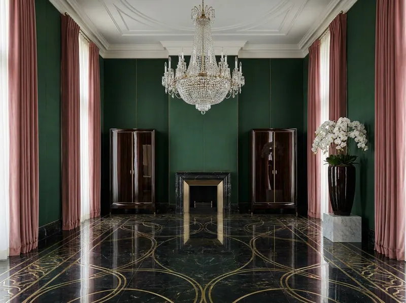 Ultra-luxury grand salon with hand-stretched silk walls in forest green, dusty rose silk velvet drapery, rock-crystal chandelier and book-matched marble floor with brass inlay — Beverly Hills Luxury Interiors microplastic-free design
